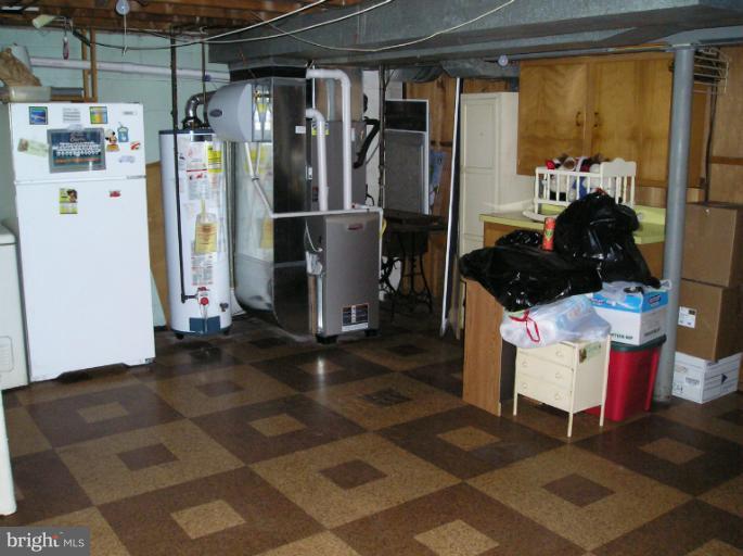 6813 Queens Ferry Road Baltimore, MD 21239 - Photo 16 of 19 a kitchen with a refrigerator and a stove