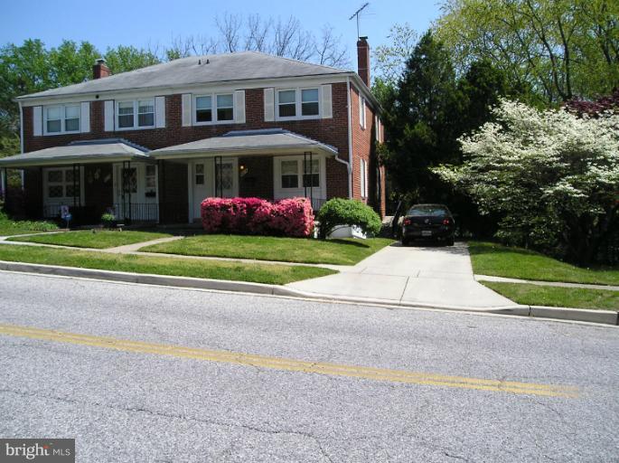 6813 Queens Ferry Road Baltimore, MD 21239 - Photo 17 of 19 a front view of building with yard and green space