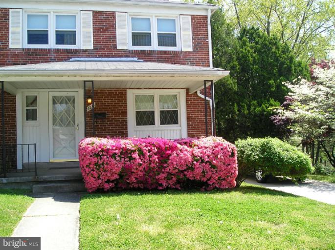 6813 Queens Ferry Road Baltimore, MD 21239 - Photo 19 of 19 a front view of a building with a garden