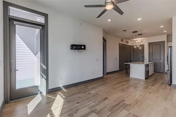 a view of a livingroom with a ceiling fan hardwood floor and a ceiling fan