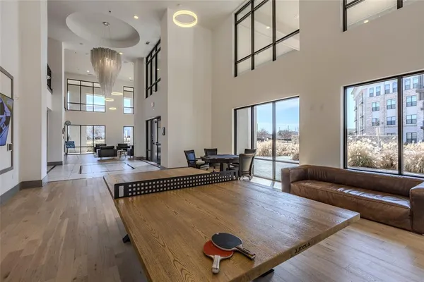 a living room with furniture rug and large windows