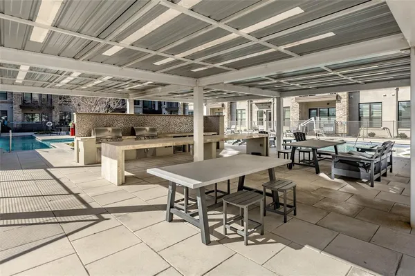 a view of a patio with couches and table and chairs and potted plants