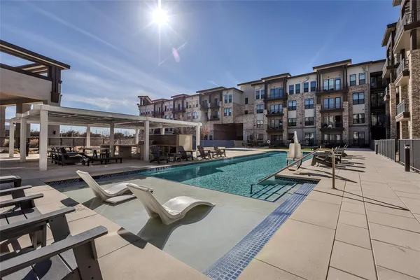 a view of swimming pool with outdoor seating