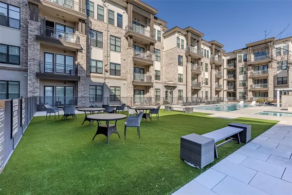 a swimming pool with outdoor seating and yard