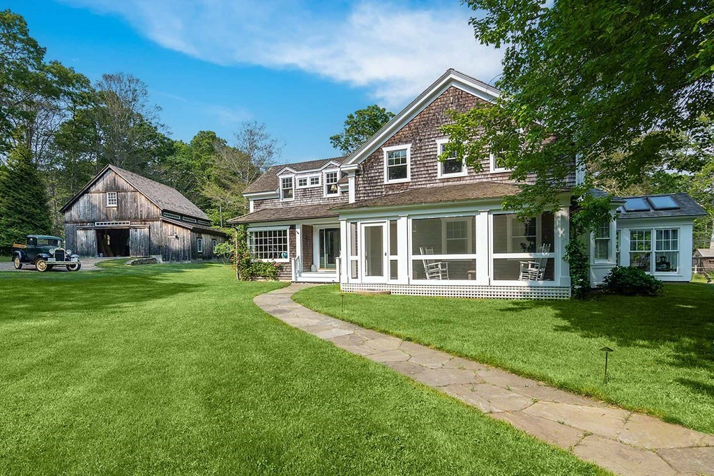 23 Indian Hollow Road West Tisbury, MA 02568 - Photo 1 of 42 front view of a house with a yard