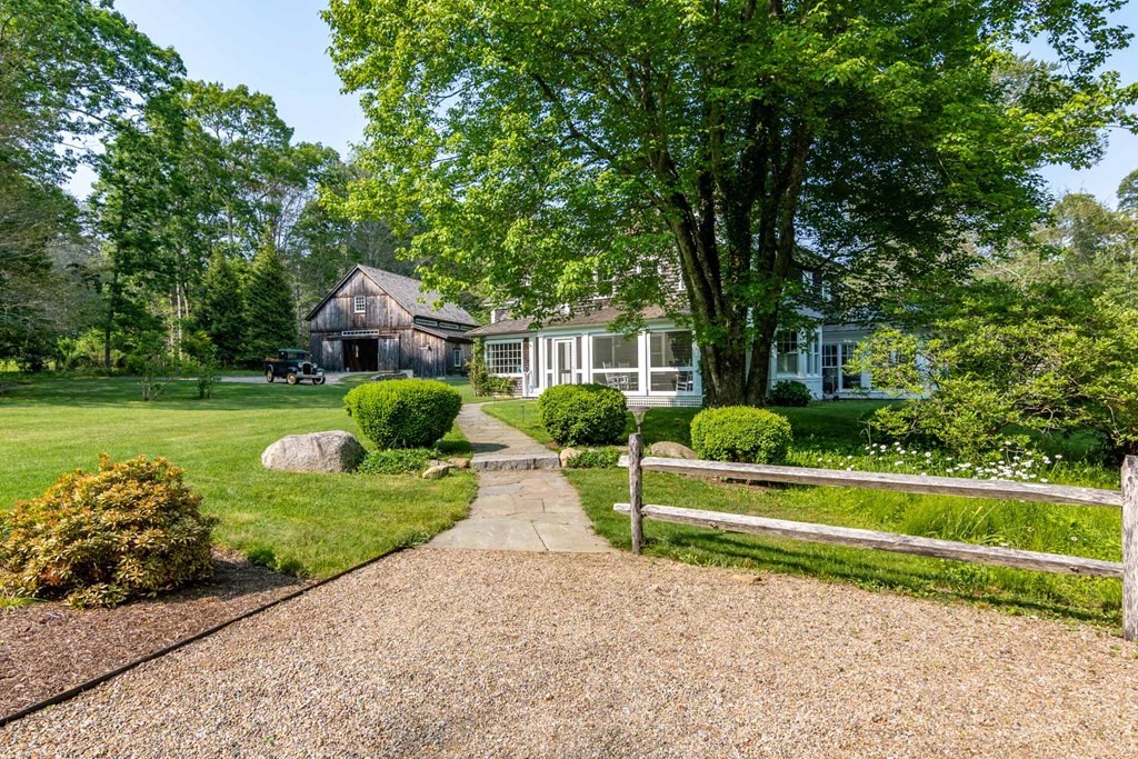23 Indian Hollow Road West Tisbury, MA 02568 - Photo 2 of 42 a front view of a house with a yard
