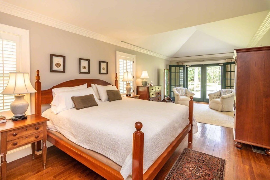 23 Indian Hollow Road West Tisbury, MA 02568 - Photo 23 of 42 a spacious bedroom with a bed and wooden floor