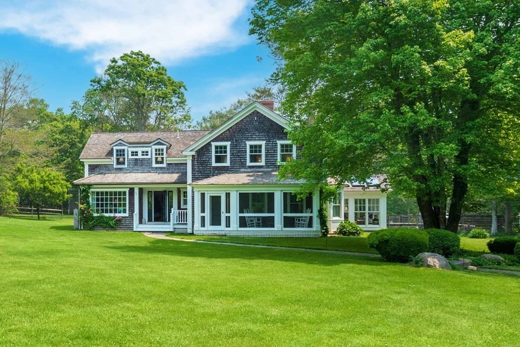 23 Indian Hollow Road West Tisbury, MA 02568 - Photo 3 of 42 a front view of a house with a garden