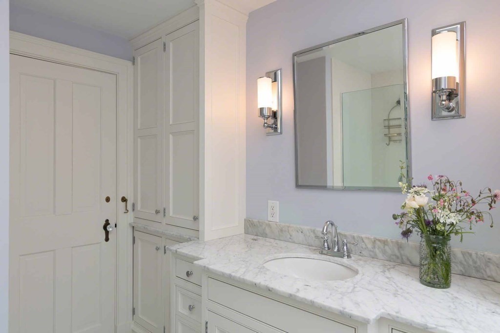 23 Indian Hollow Road West Tisbury, MA 02568 - Photo 32 of 42 a bathroom with a granite countertop sink a mirror and a shower
