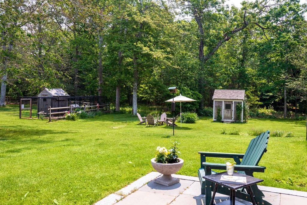 23 Indian Hollow Road West Tisbury, MA 02568 - Photo 5 of 42 a view of a chairs and table in the garden