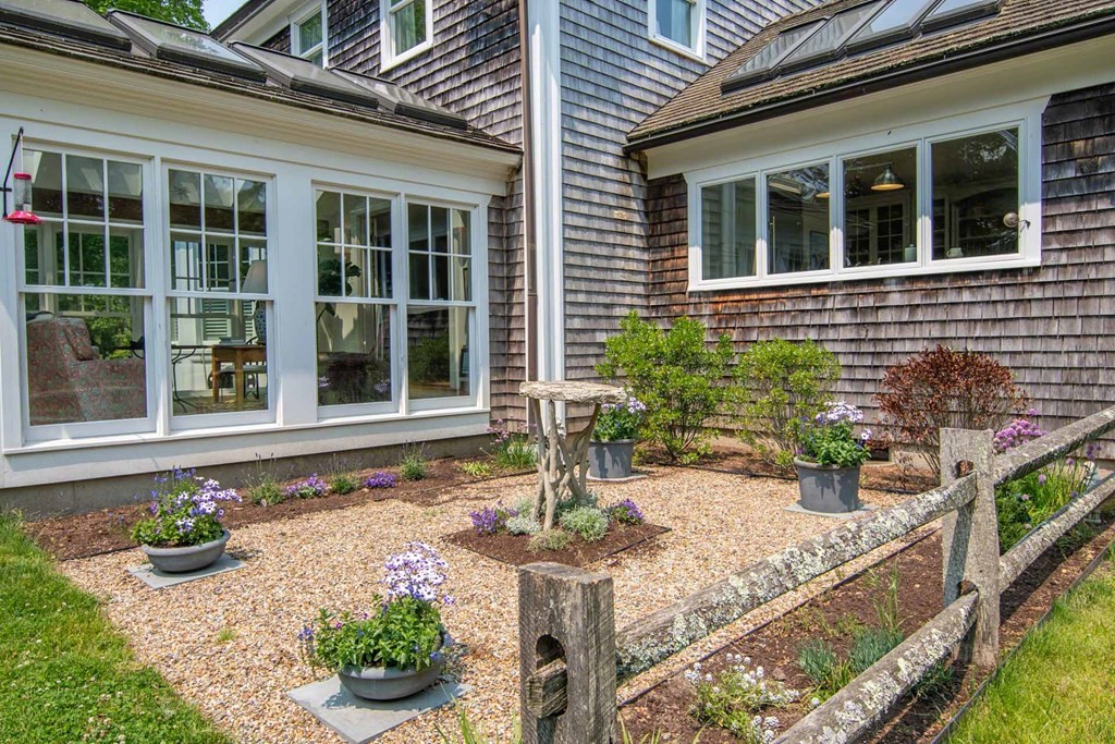 23 Indian Hollow Road West Tisbury, MA 02568 - Photo 7 of 42 front view of a house with potted plants