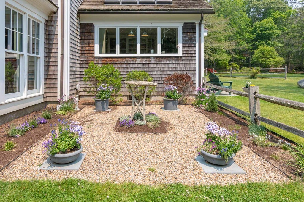23 Indian Hollow Road West Tisbury, MA 02568 - Photo 8 of 42 a view of a backyard with chair and garden