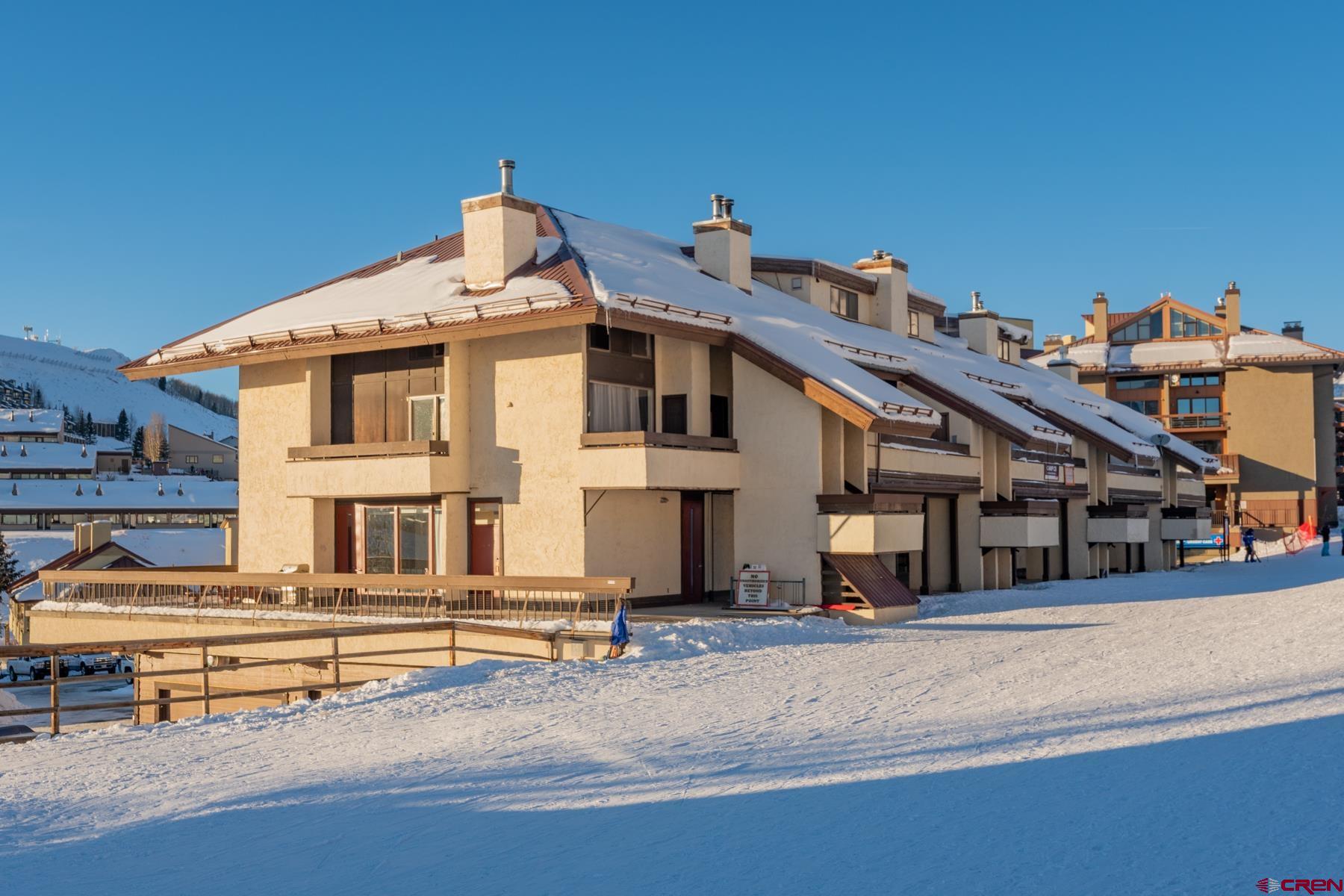14 Snowmass Road, Unit 301 Crested Butte, CO 81225 - Photo 1 of 35 a view of a house with large windows