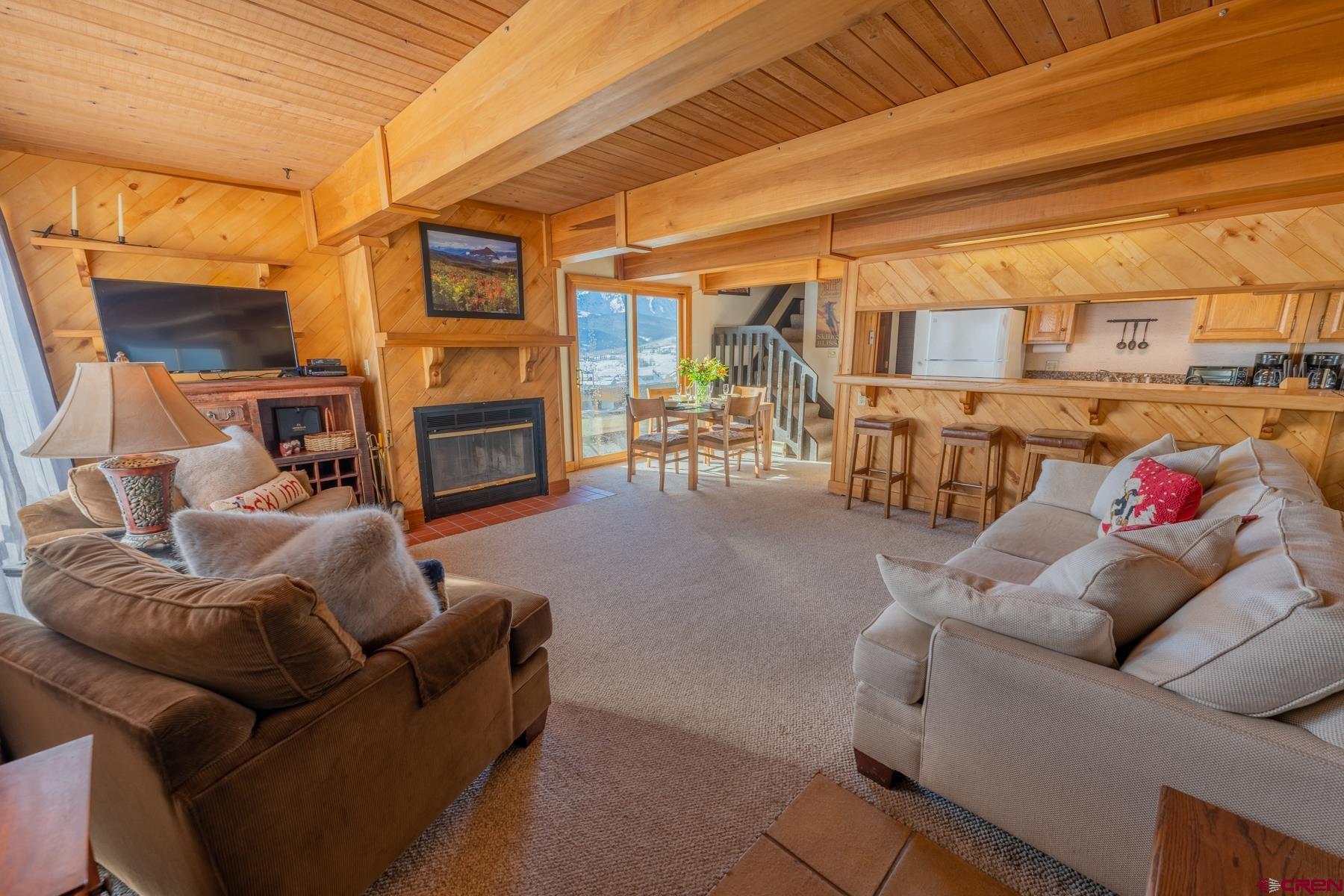 14 Snowmass Road, Unit 301 Crested Butte, CO 81225 - Photo 2 of 35 a living room with furniture and a fireplace