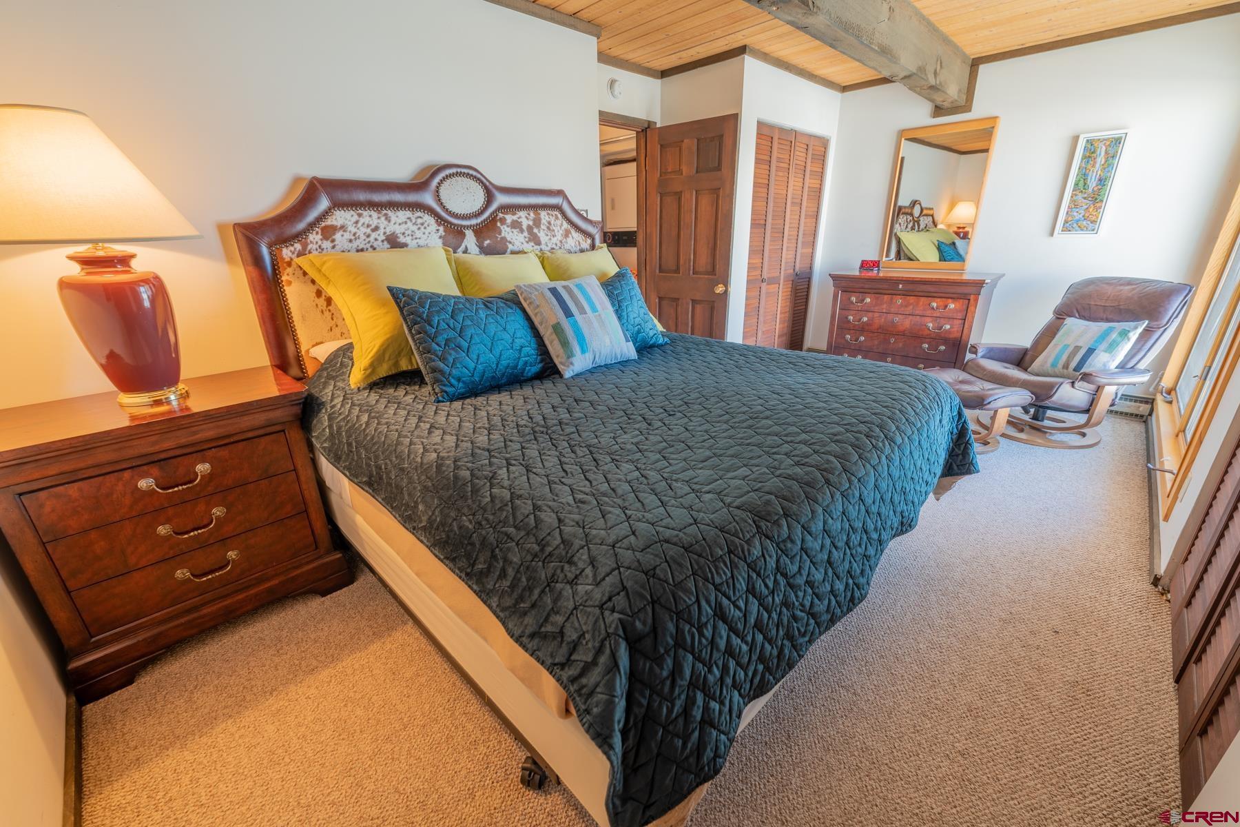 14 Snowmass Road, Unit 301 Crested Butte, CO 81225 - Photo 13 of 35 a bed sitting in a bedroom next to a window