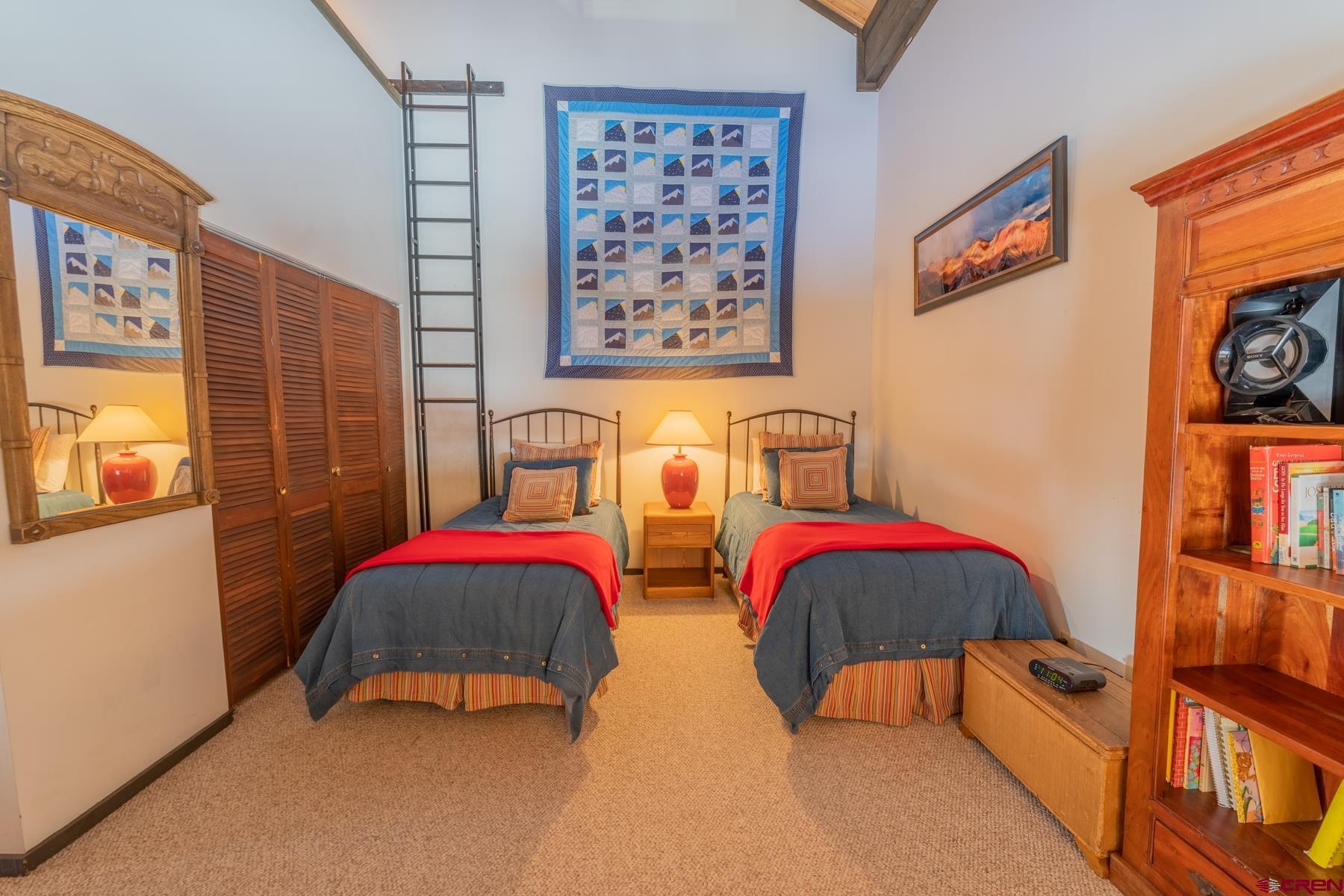 14 Snowmass Road, Unit 301 Crested Butte, CO 81225 - Photo 18 of 35 a bedroom with two beds and a painting on the wall