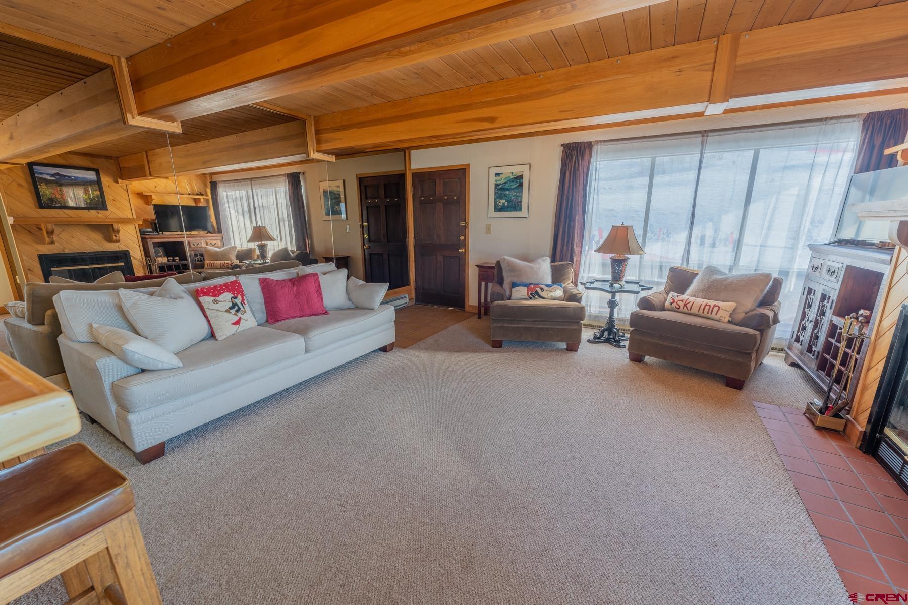 14 Snowmass Road, Unit 301 Crested Butte, CO 81225 - Photo 3 of 35 a living room with furniture and a window