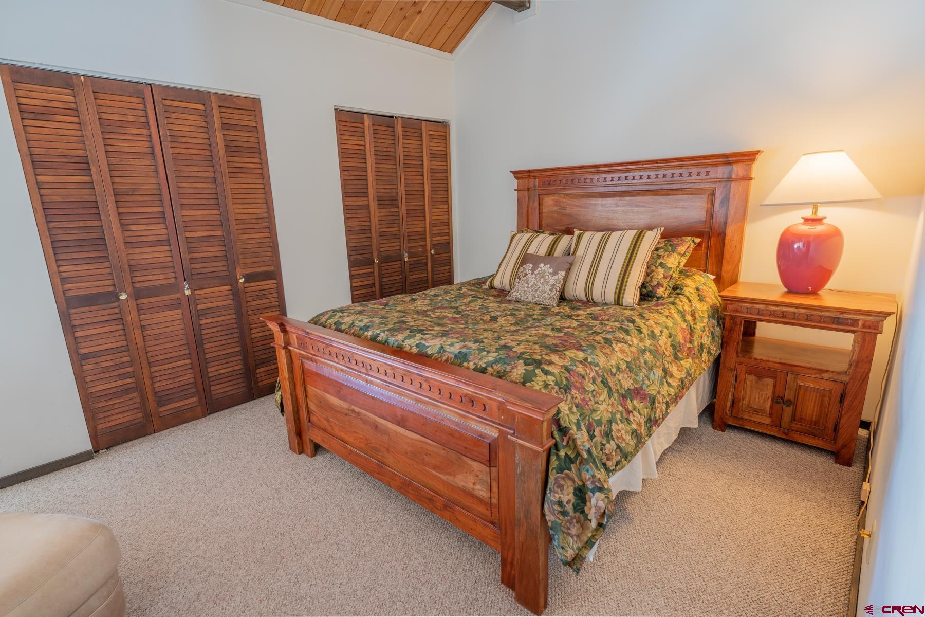 14 Snowmass Road, Unit 301 Crested Butte, CO 81225 - Photo 24 of 35 a bed sitting in a bedroom next to a window