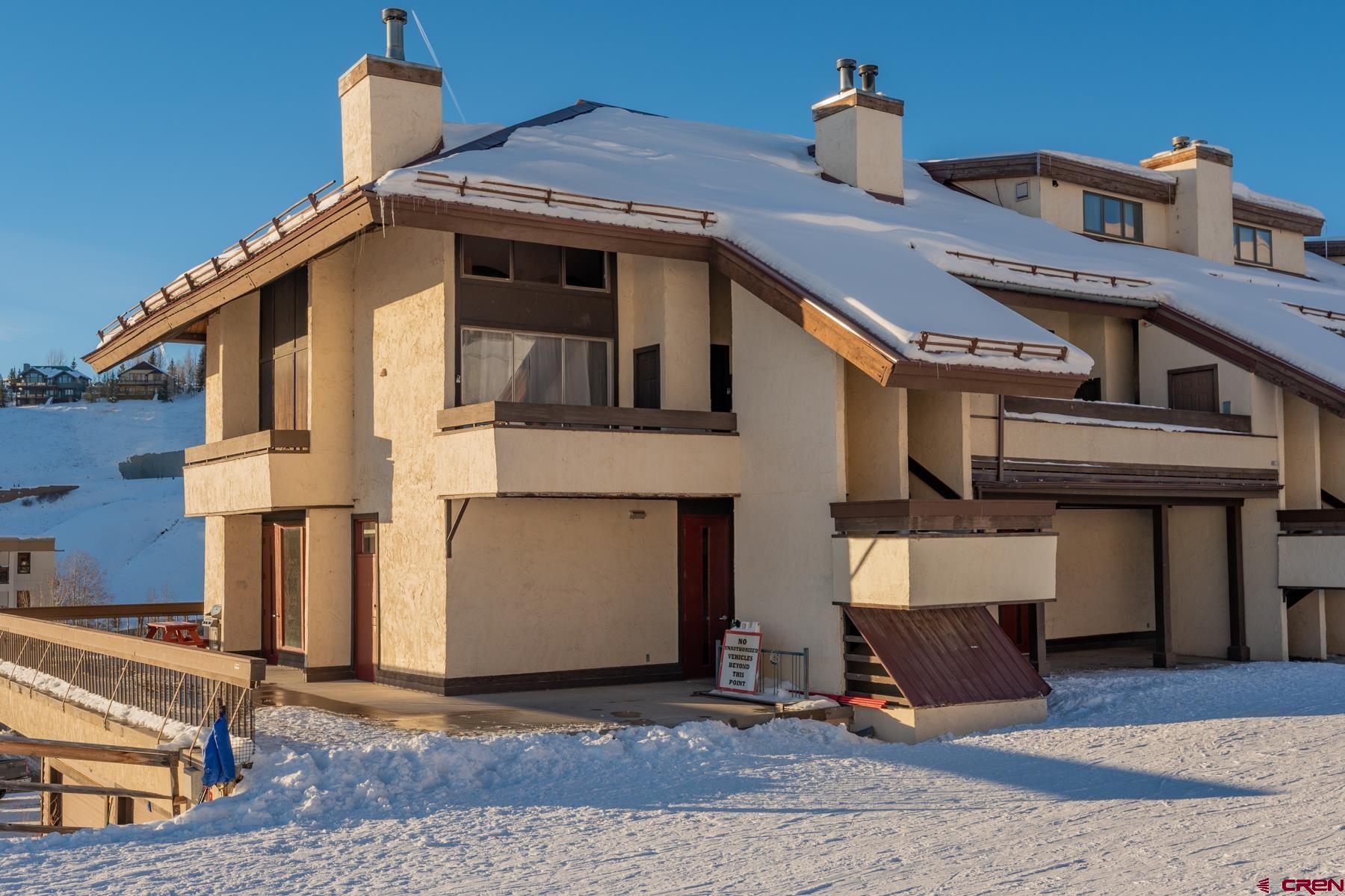 14 Snowmass Road, Unit 301 Crested Butte, CO 81225 - Photo 25 of 35 a front view of a house with a yard