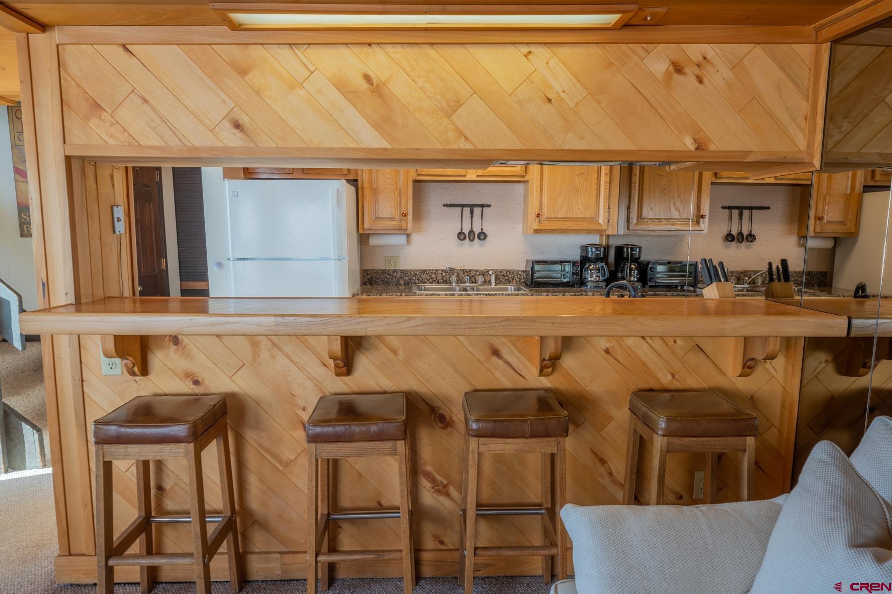 14 Snowmass Road, Unit 301 Crested Butte, CO 81225 - Photo 4 of 35 a view of a patio with table and chairs and wooden floor