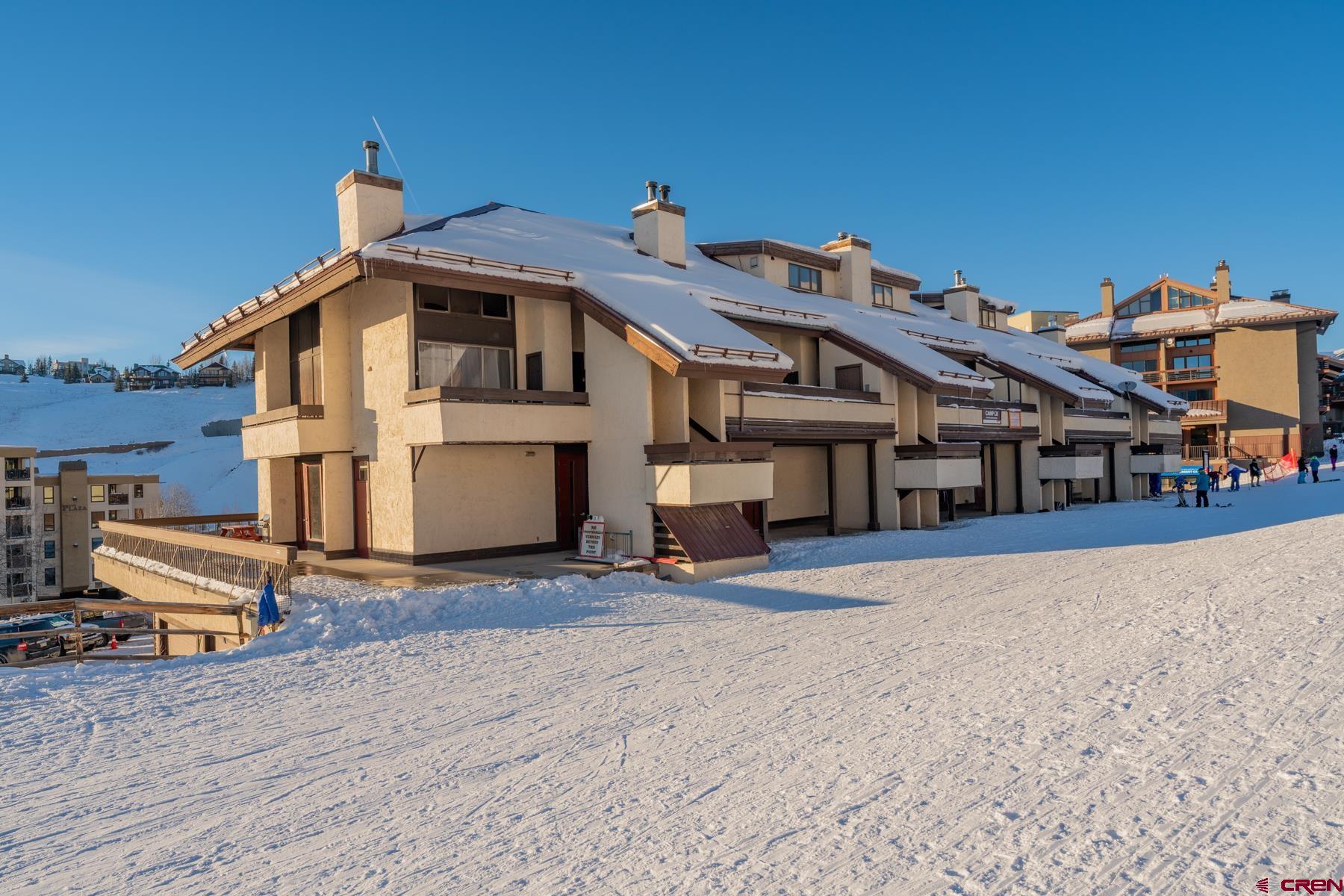 14 Snowmass Road, Unit 301 Crested Butte, CO 81225 - Photo 34 of 35 a front view of a house with a yard