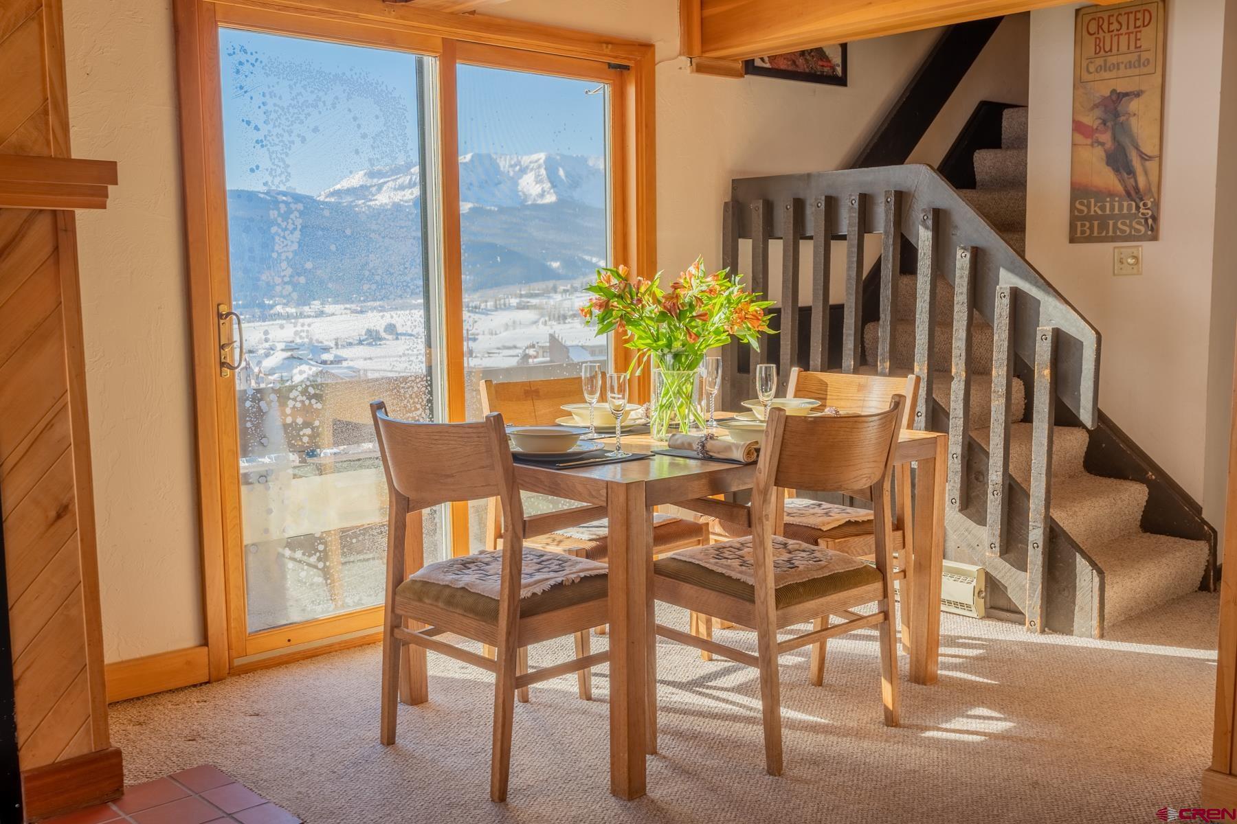 14 Snowmass Road, Unit 301 Crested Butte, CO 81225 - Photo 5 of 35 a dining room with furniture and wooden floor