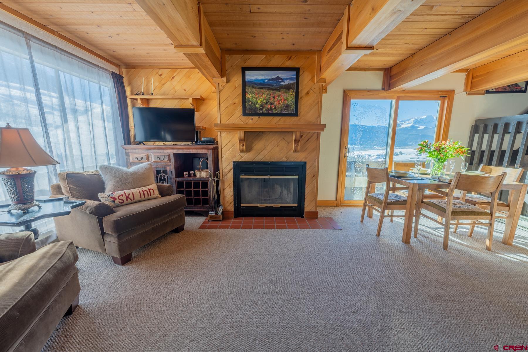 14 Snowmass Road, Unit 301 Crested Butte, CO 81225 - Photo 6 of 35 a living room with furniture and a fireplace