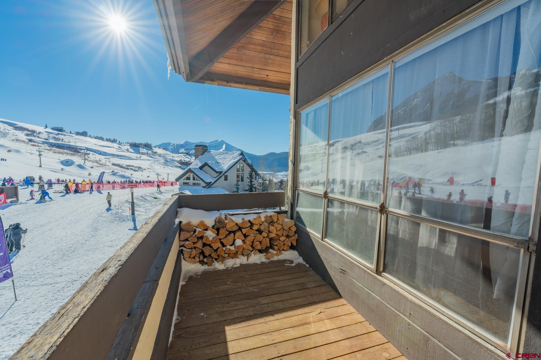 14 Snowmass Road, Unit 301 Crested Butte, CO 81225 - Photo 7 of 35 a view of a balcony with wooden floor and iron stairs