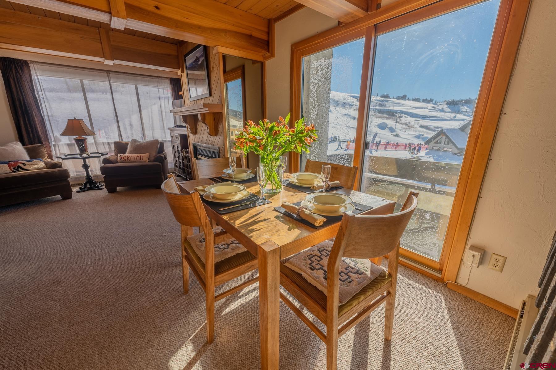 14 Snowmass Road, Unit 301 Crested Butte, CO 81225 - Photo 10 of 35 a dining room with furniture and window