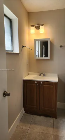 a bathroom with a sink vanity and mirror