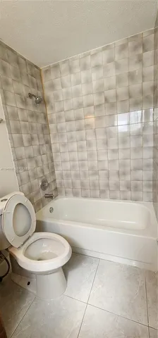 a bathroom with a toilet and a bathtub