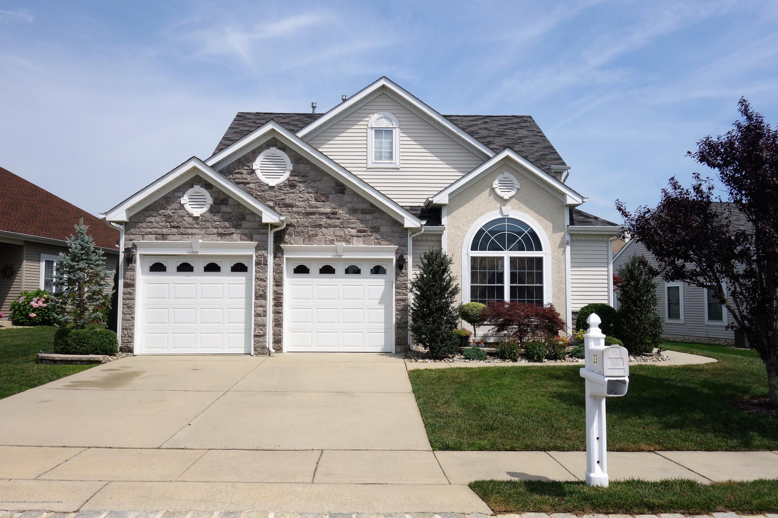 33 Pancoast Road Waretown, NJ 08758 - Photo 1 of 27 a front view of a house with a yard and garage