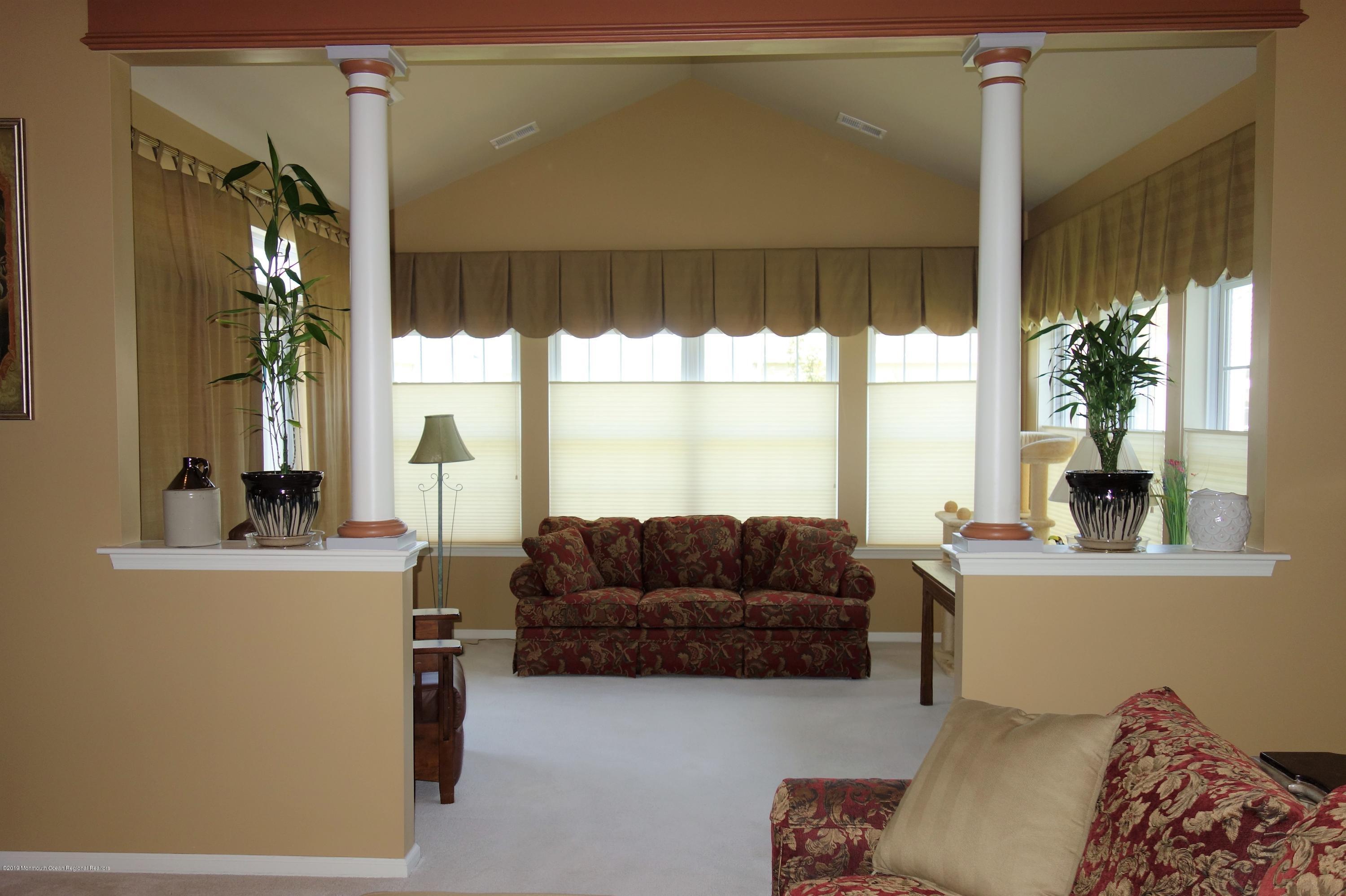 33 Pancoast Road Waretown, NJ 08758 - Photo 12 of 27 a living room with furniture and a large window