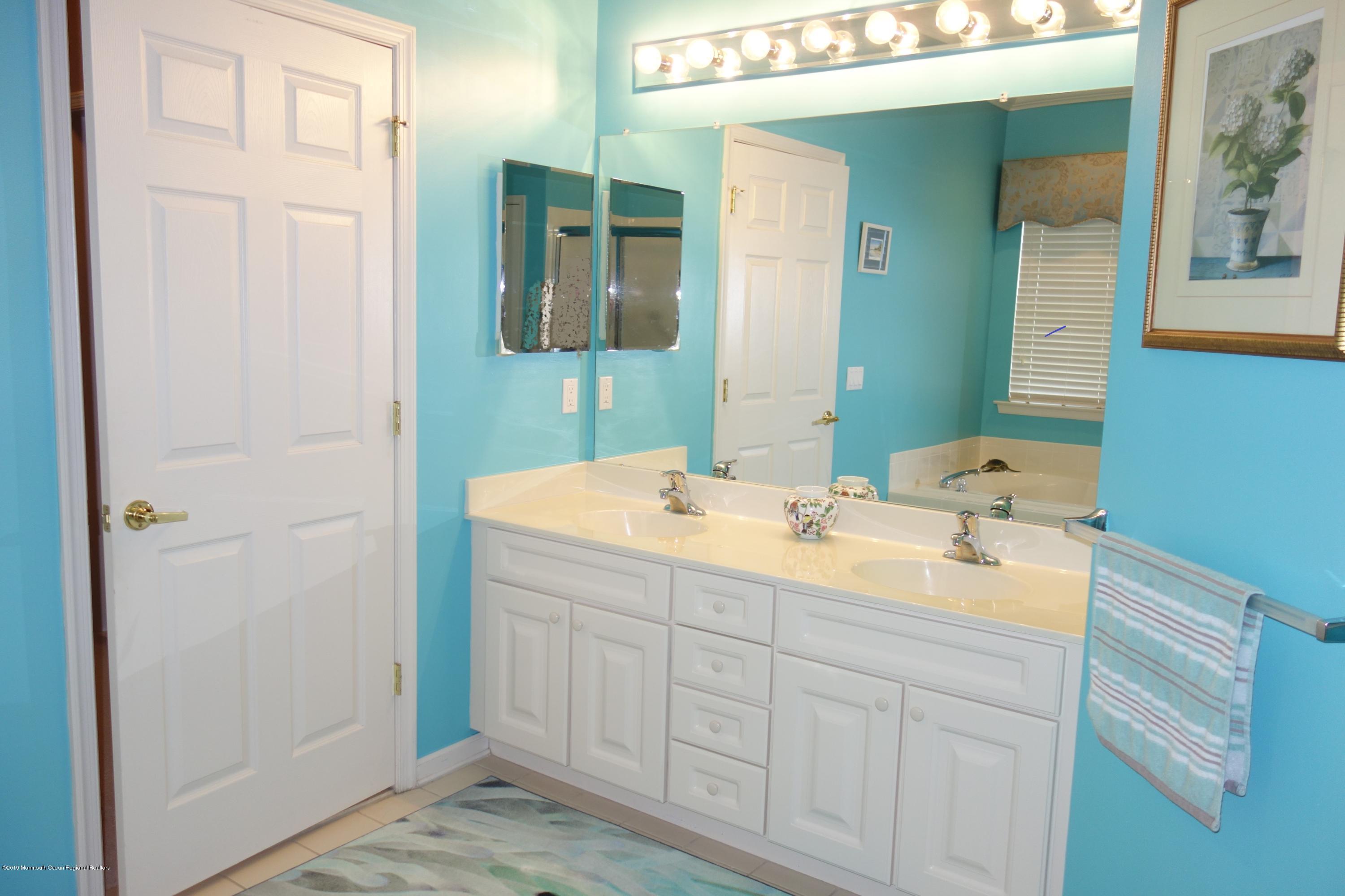 33 Pancoast Road Waretown, NJ 08758 - Photo 16 of 27 a bathroom with a double vanity sink and a mirror