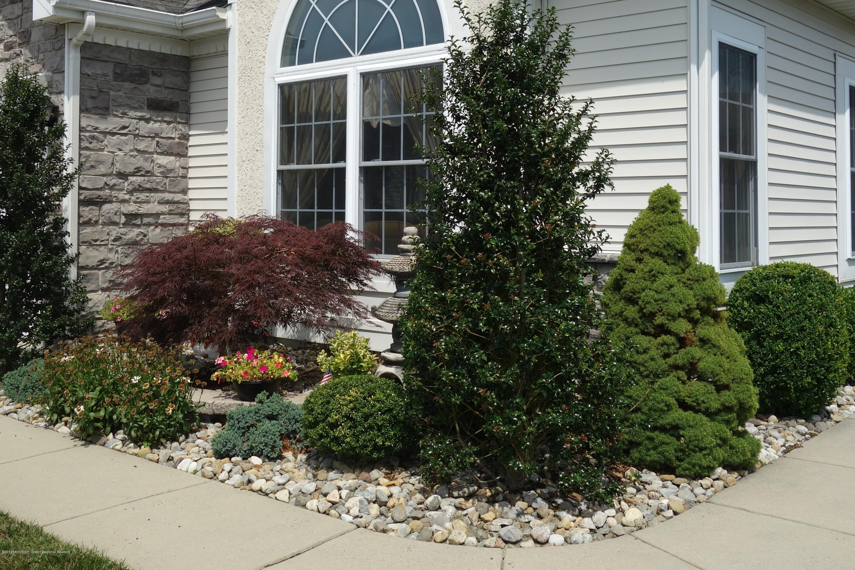 33 Pancoast Road Waretown, NJ 08758 - Photo 2 of 27 a view of a garden with potted plants