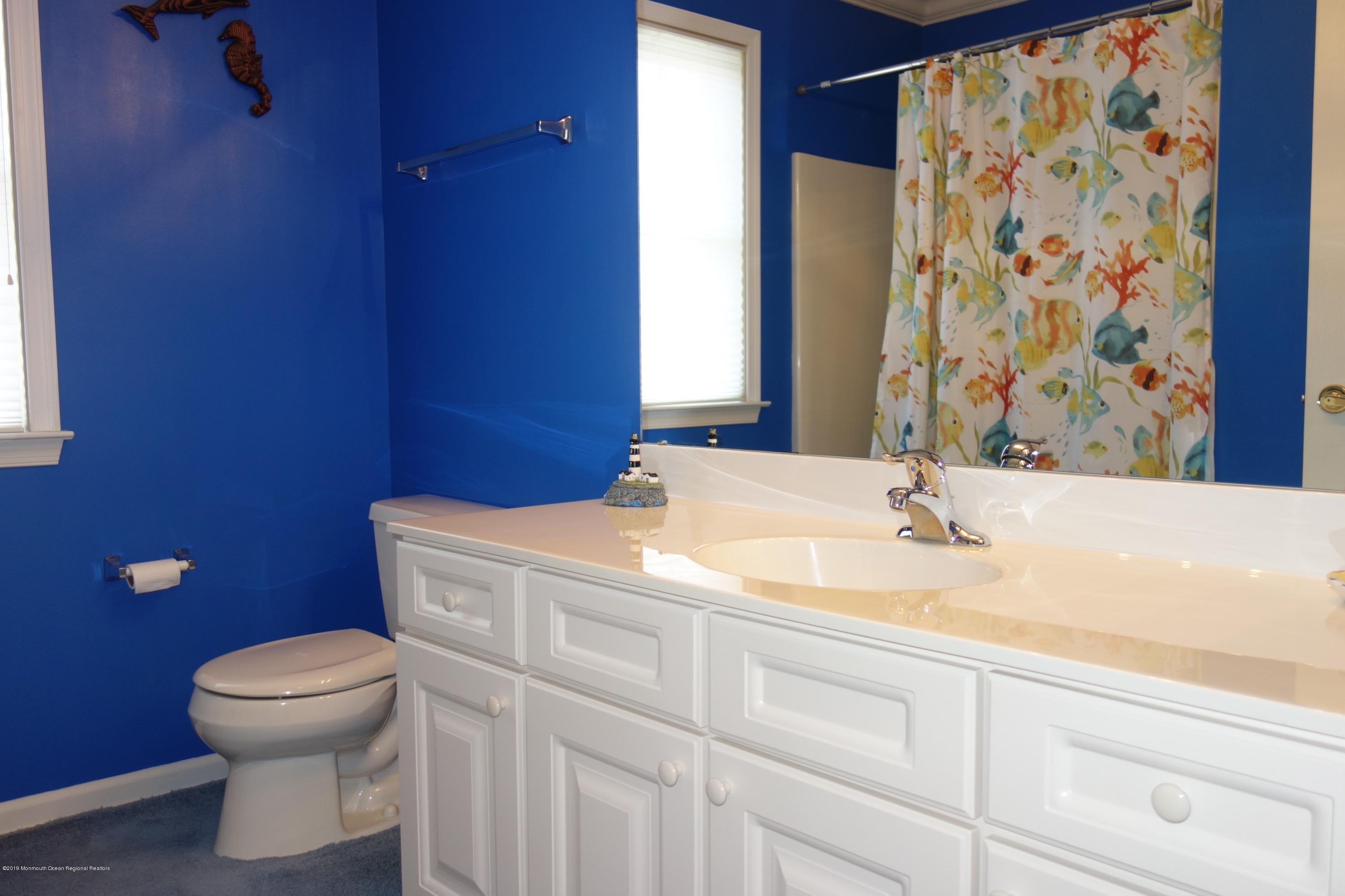 33 Pancoast Road Waretown, NJ 08758 - Photo 21 of 27 a bathroom with a granite countertop toilet sink and mirror