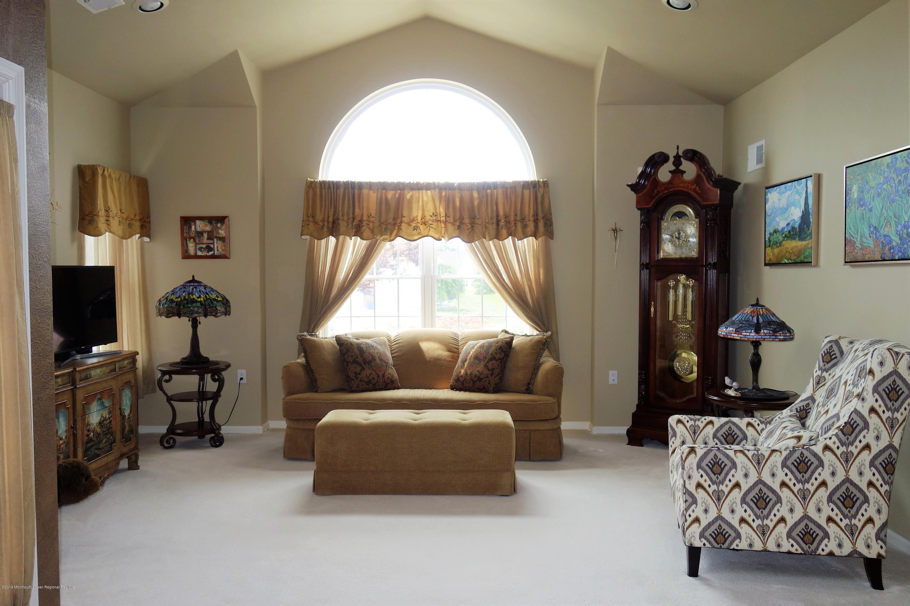 33 Pancoast Road Waretown, NJ 08758 - Photo 4 of 27 a living room with furniture and a flat screen tv