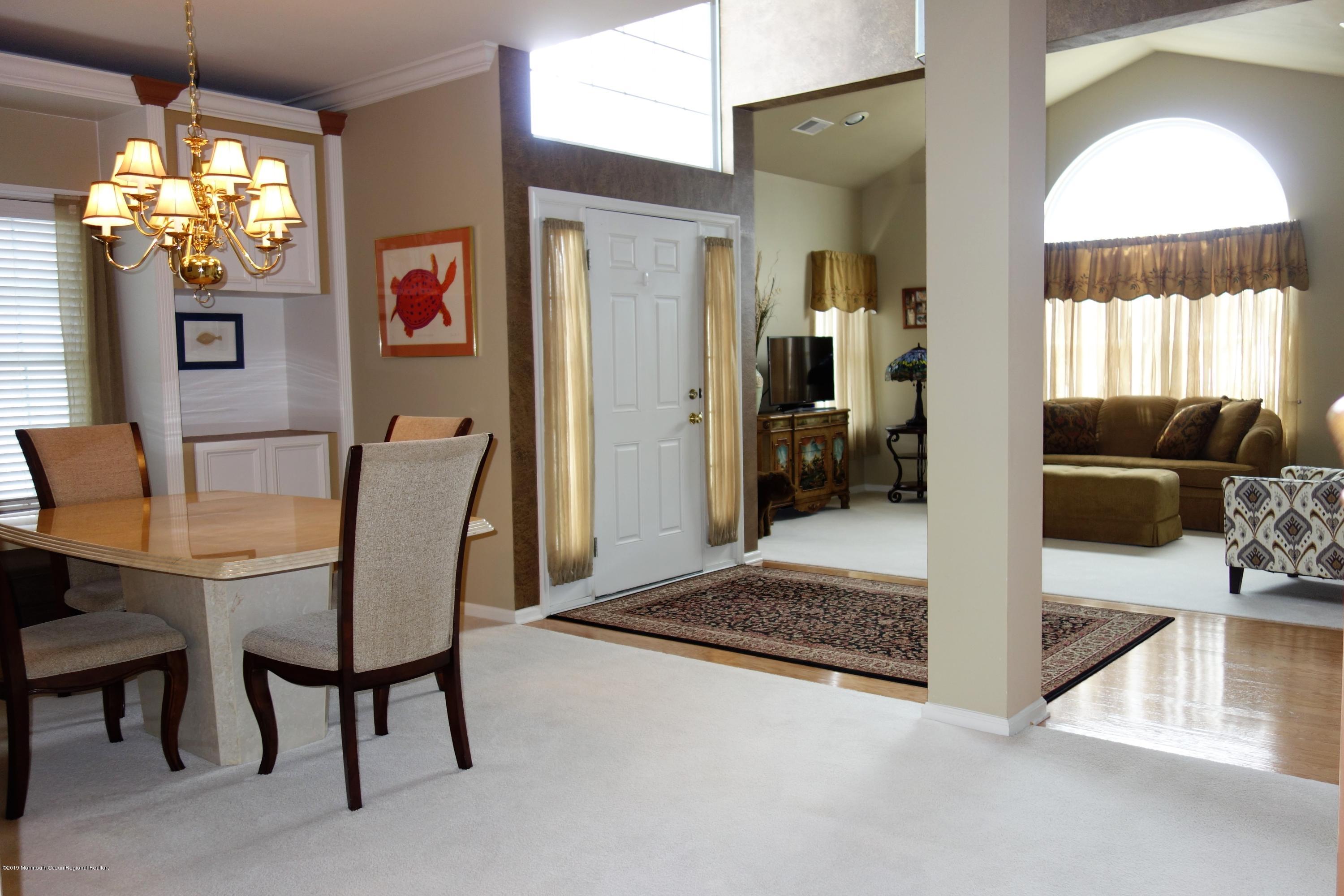 33 Pancoast Road Waretown, NJ 08758 - Photo 7 of 27 a view of a dining room with furniture and a chandelier