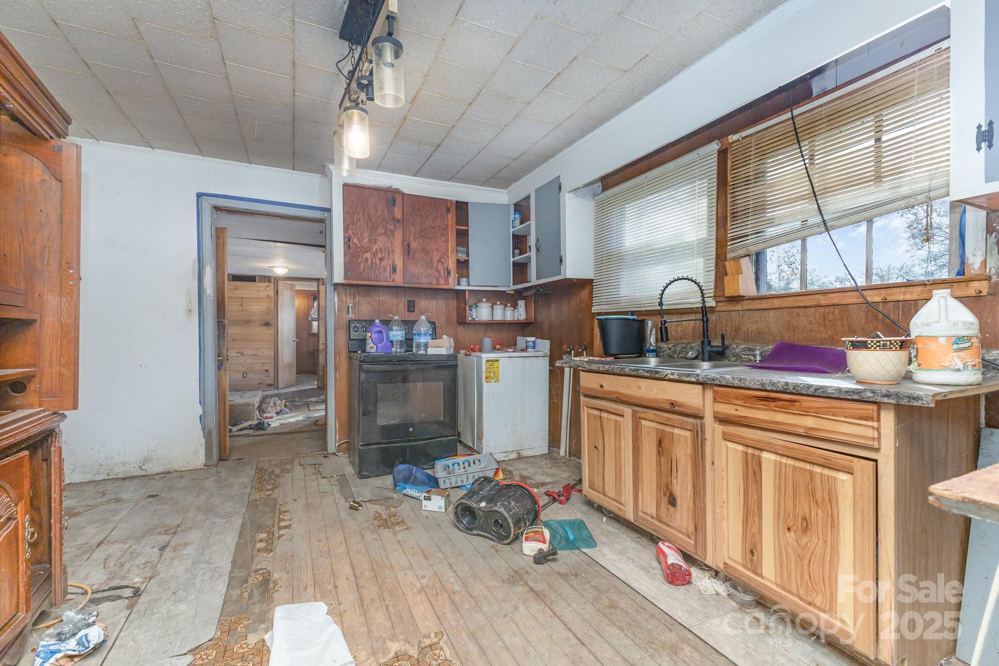 617 Hames Ridge Road Mooresboro, NC 28114 - Photo 10 of 20 a kitchen with a refrigerator and a sink
