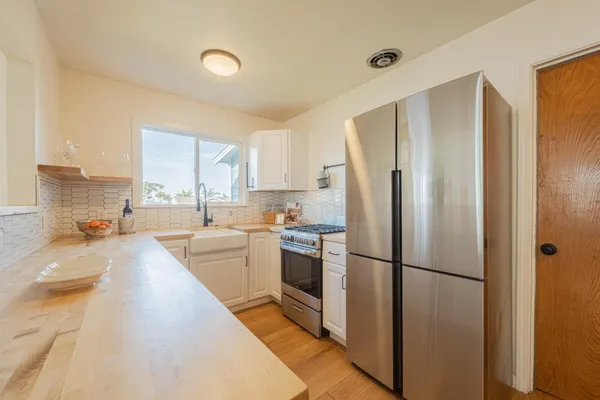a kitchen with a refrigerator a sink and a stove