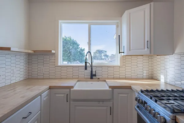 a kitchen with a sink and cabinets