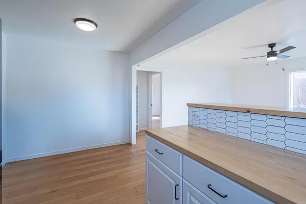 a view of kitchen with granite countertop cabinets and wooden floor
