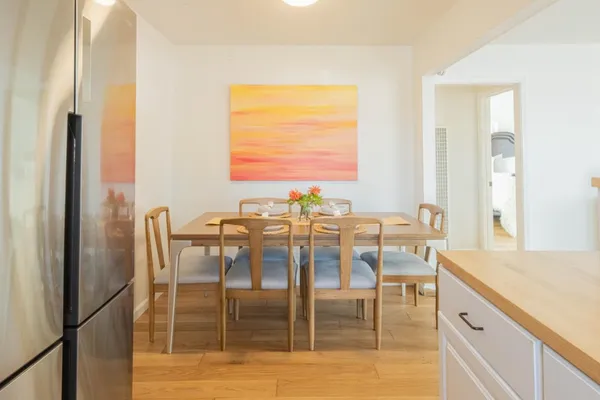 a view of a dining room with furniture and wooden floor