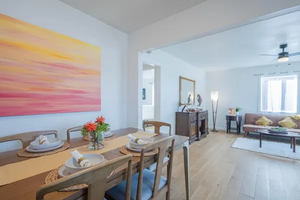 a view of a dining room with furniture and wooden floor