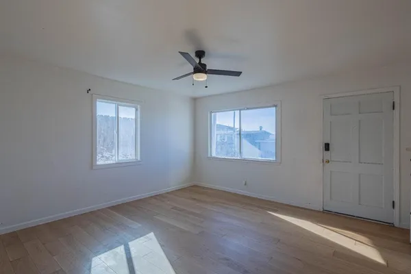 wooden floor in an empty room with a window