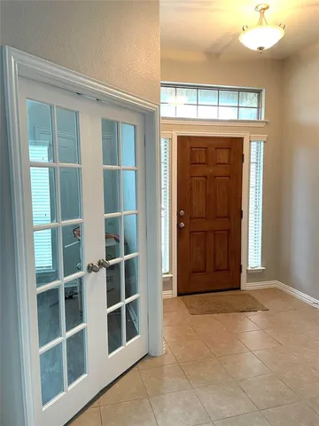 a view of front door with wooden door