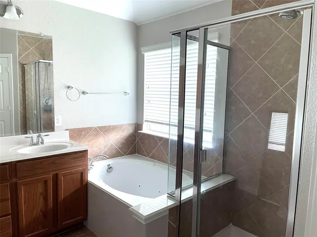 a bathroom with a granite countertop sink a toilet and shower