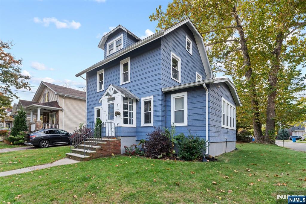 177 East Pierrepont Avenue Rutherford, NJ 07070 - Photo 3 of 27 a front view of a house with a garden and trees