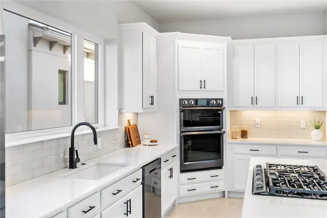 a living room with furniture and large windows