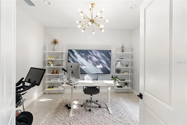 a view of a hallway with wooden floor and windows